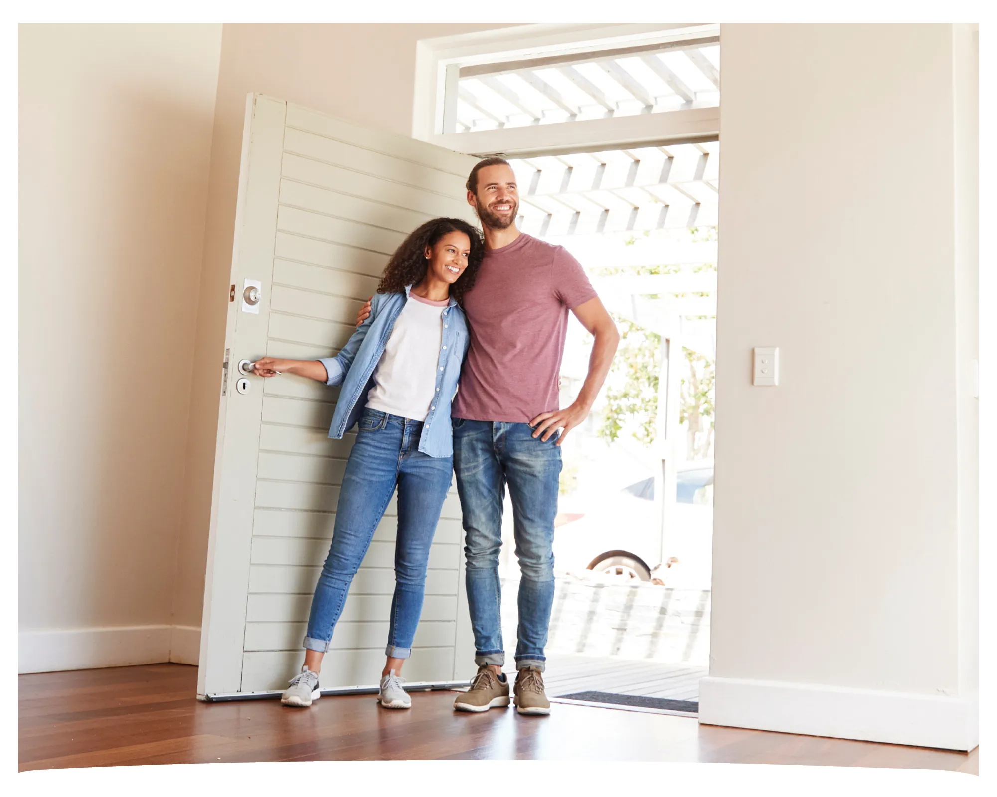 Young couple walking into their new home.