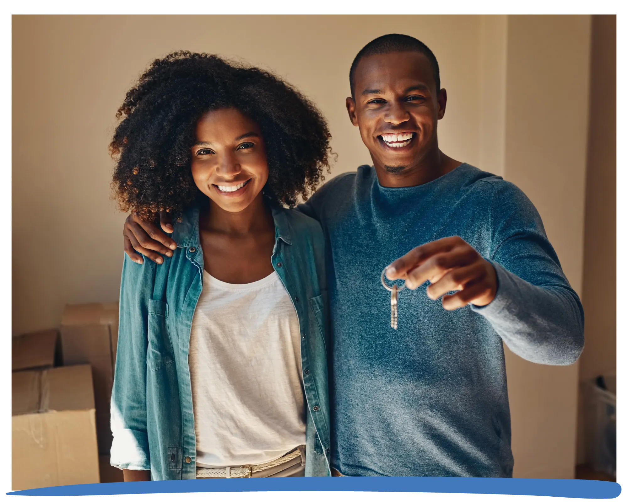 Young couple happy holding new house keys.