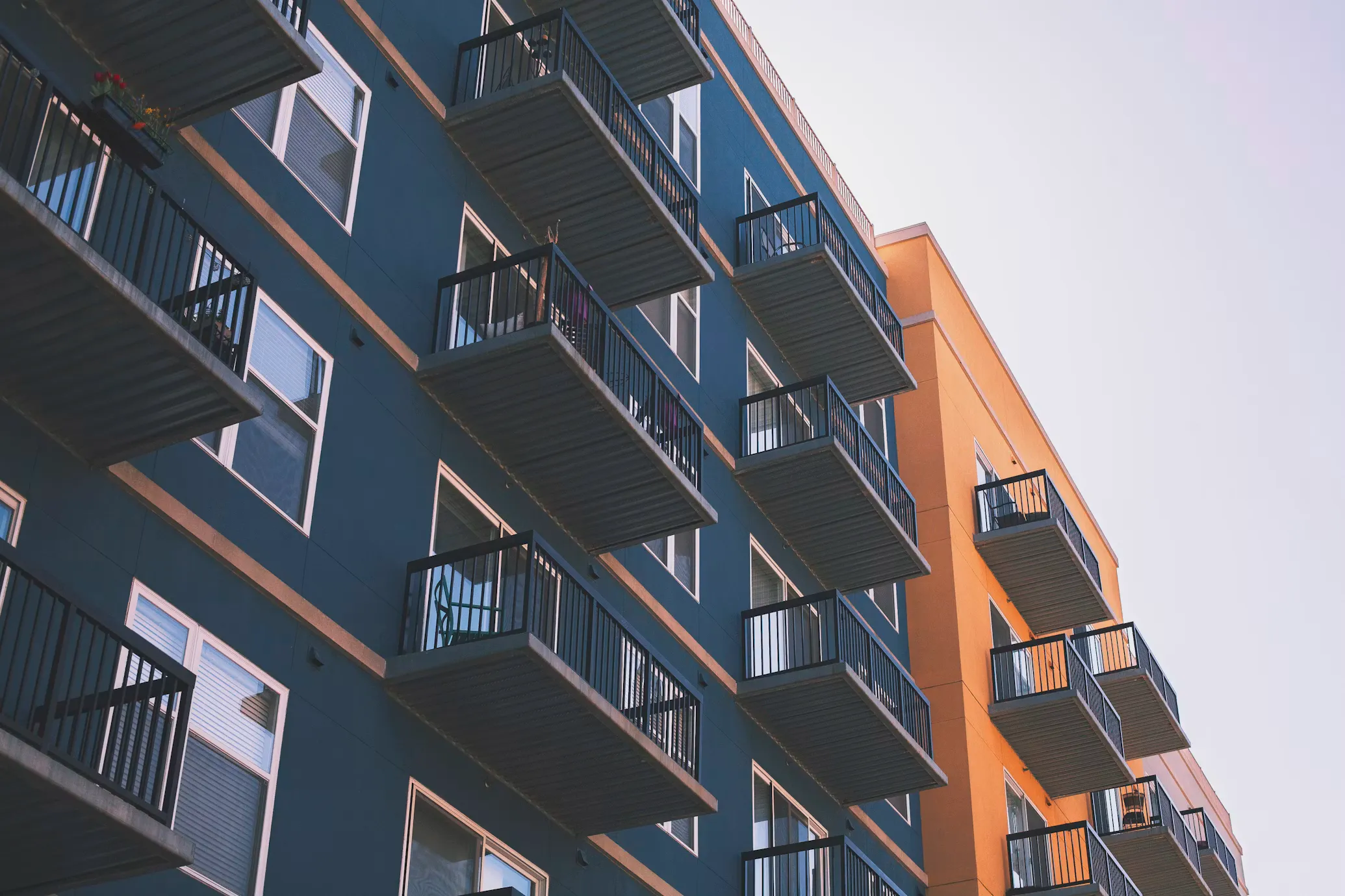A multi-story condominium or apartment building with private balconies, representing urban housing and condo living.