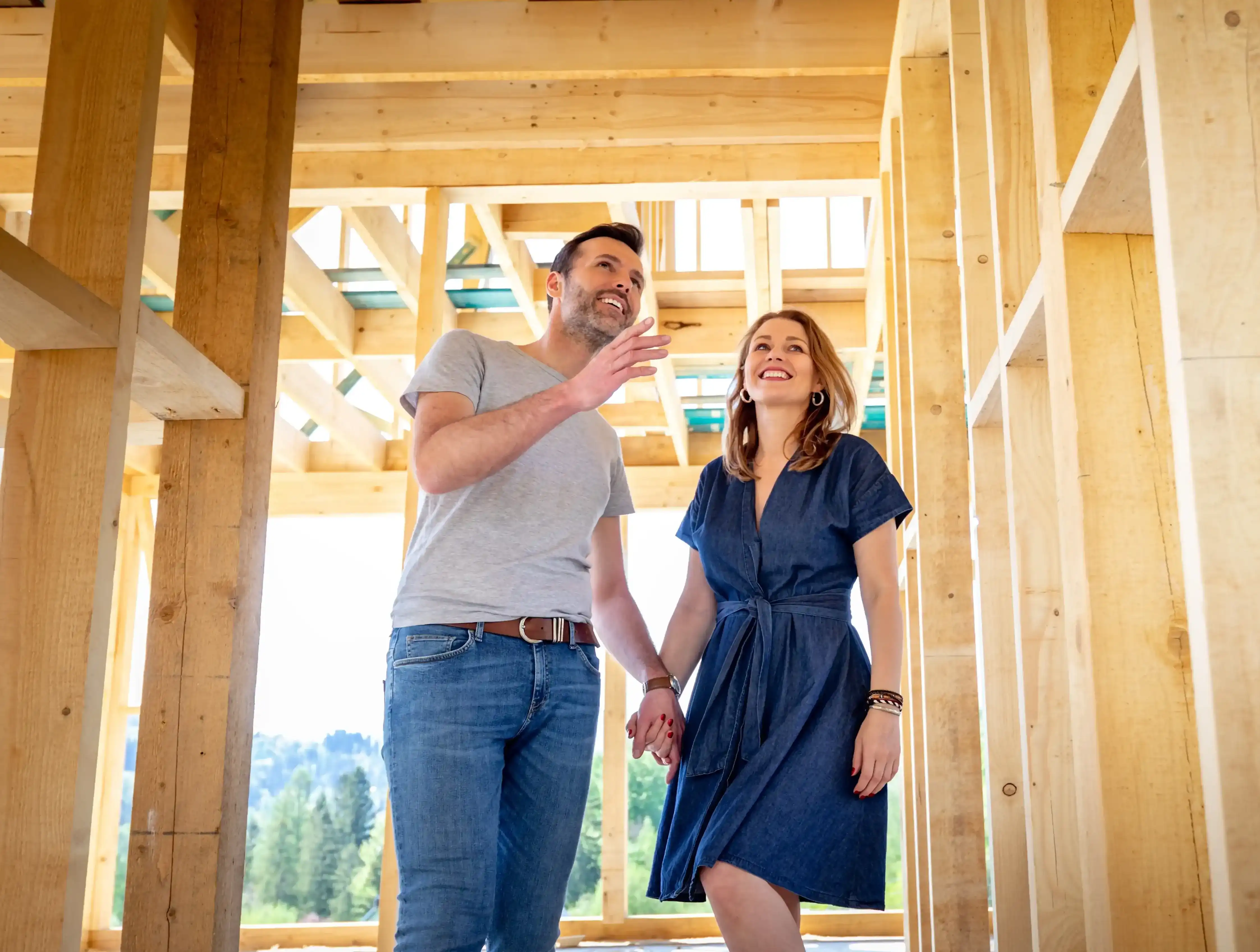 Couple Walking Through In Progress Home Construction