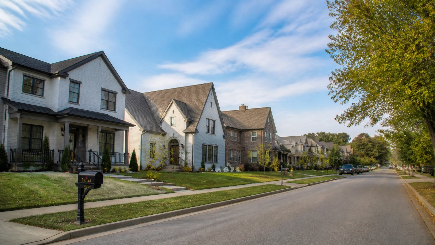 Beautiful suburban neighborhood with modern single-family homes and tree-lined residential street.